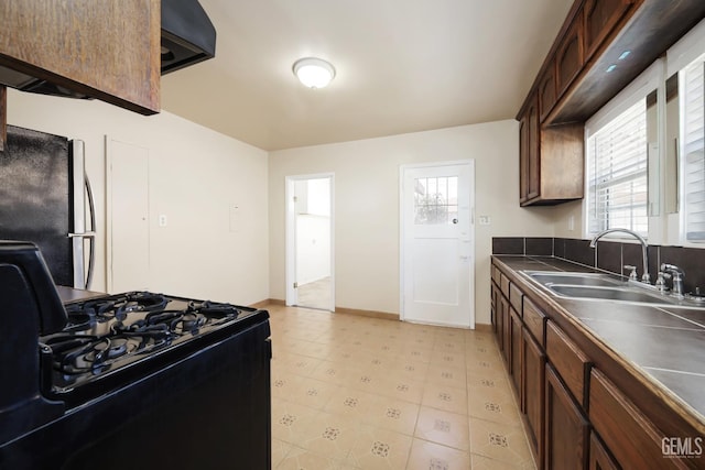 814 Eureka St, Bakersfield, CA 93305 - kitchen featuring black range with gas cooktop, freestanding refrigerator, and dark countertops