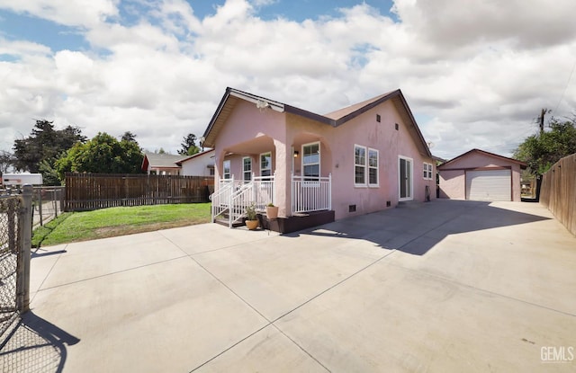 814 Eureka St, Bakersfield, CA 93305 - view of front of property with covered porch, an outbuilding, a detached garage, stucco siding, and concrete driveway