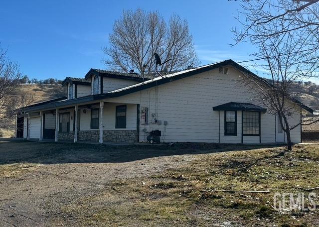 back of property featuring a lawn