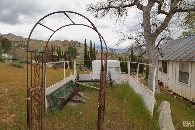 view of yard with cooling unit, fence, and a mountain view