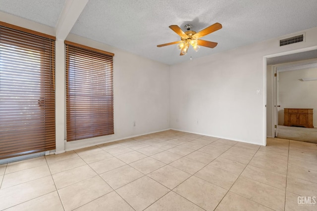 3504 Elm St, Bakersfield, CA 93301 - unfurnished bedroom with light tile patterned flooring, a textured ceiling, ceiling fan, and baseboards