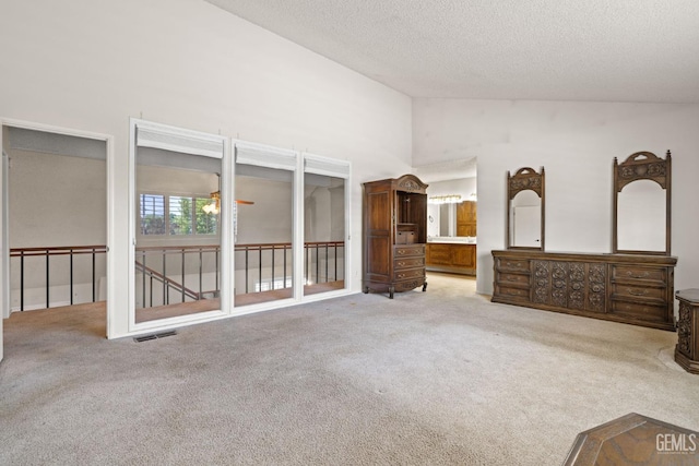 3504 Elm St, Bakersfield, CA 93301 - unfurnished bedroom with carpet, a textured ceiling, ensuite bathroom, and high vaulted ceiling