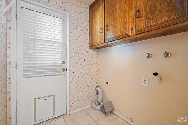 3504 Elm St, Bakersfield, CA 93301 - washroom featuring electric dryer hookup, cabinet space, hookup for a gas dryer, light tile patterned flooring, and baseboards