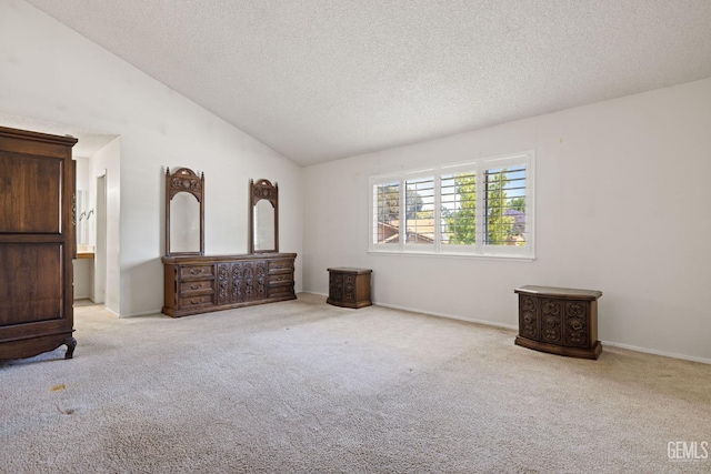3504 Elm St, Bakersfield, CA 93301 - unfurnished bedroom with a textured ceiling, carpet, lofted ceiling, and baseboards