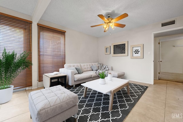 3504 Elm St, Bakersfield, CA 93301 - living area with tile patterned flooring, a ceiling fan, a textured ceiling, and baseboards