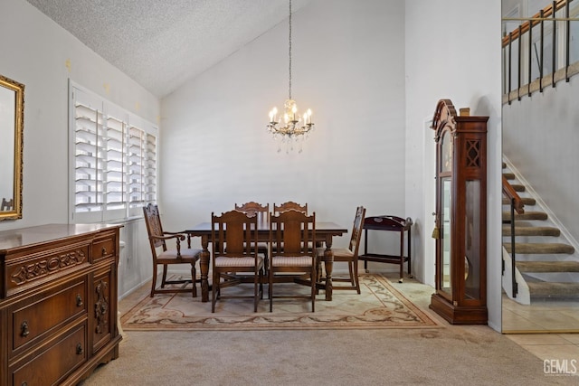 3504 Elm St, Bakersfield, CA 93301 - carpeted dining room with stairway, a chandelier, a textured ceiling, and high vaulted ceiling