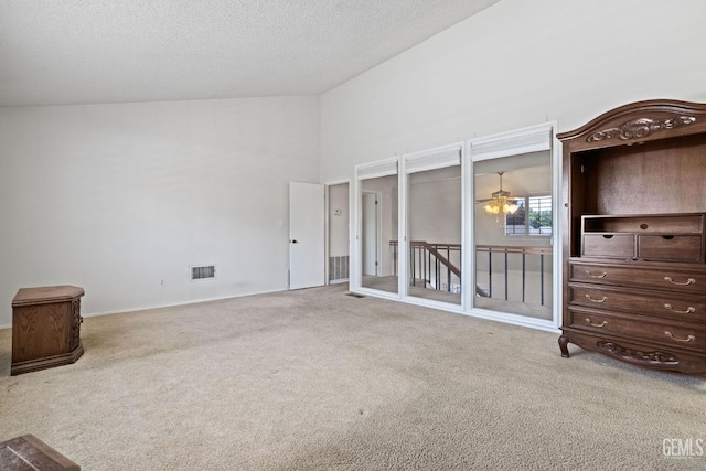 3504 Elm St, Bakersfield, CA 93301 - unfurnished bedroom with carpet floors, a textured ceiling, and a towering ceiling
