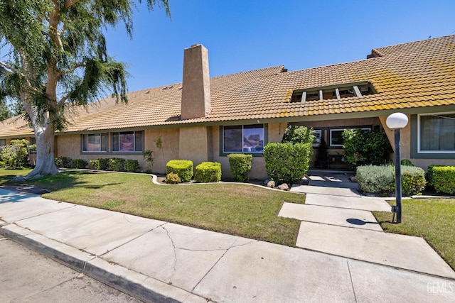 3504 Elm St, Bakersfield, CA 93301 - view of front facade with a tiled roof, a chimney, stucco siding, and a front lawn