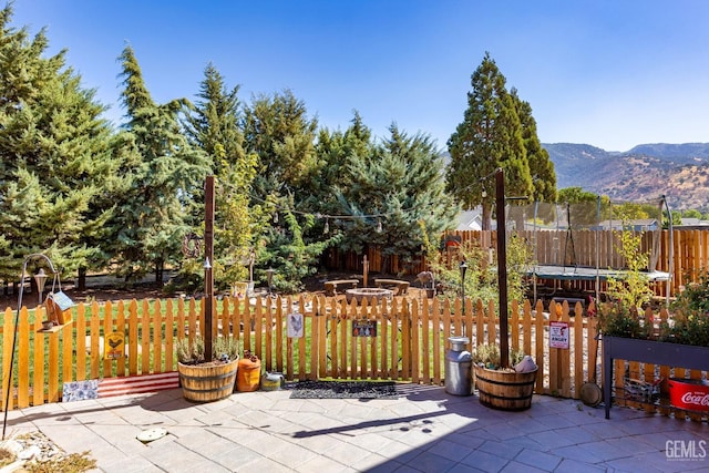 view of patio / terrace with a mountain view and a trampoline