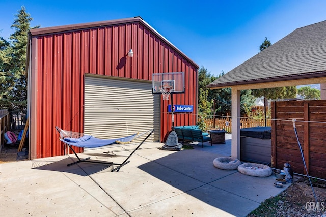 view of outbuilding featuring a garage and a hot tub