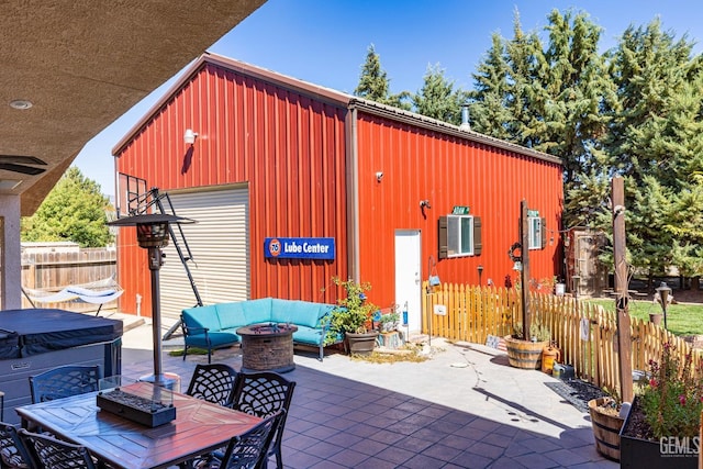 view of outbuilding featuring an outdoor living space with a fire pit