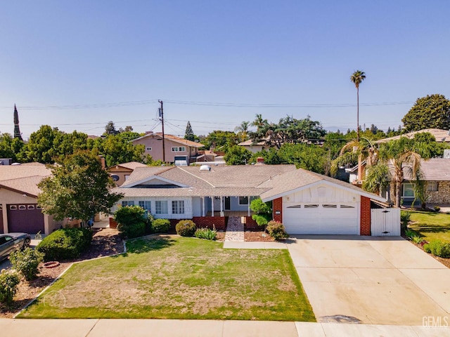 6201 Hartman Ave, Bakersfield, CA 93309 - view of front of property with driveway, a front lawn, brick siding, and a garage