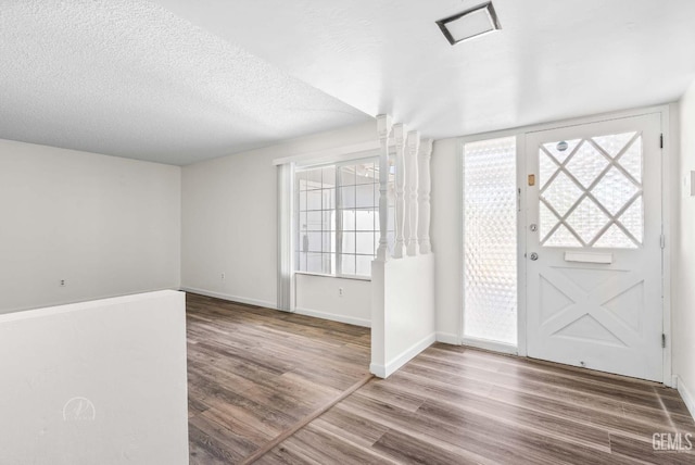 6201 Hartman Ave, Bakersfield, CA 93309 - foyer with wood finished floors, baseboards, and a textured ceiling