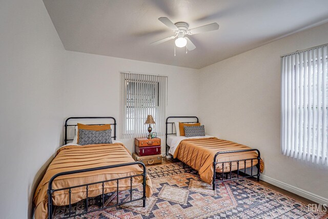 2849 Alturas Dr, Bakersfield, CA 93305 - bedroom with wood finished floors, baseboards, and multiple windows