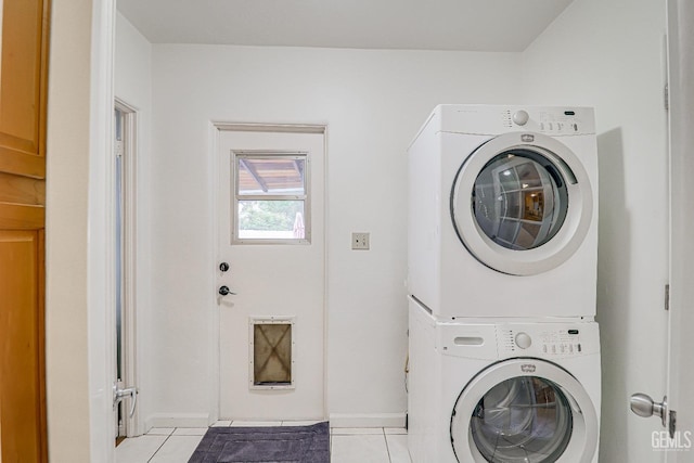 2849 Alturas Dr, Bakersfield, CA 93305 - clothes washing area with stacked washer and dryer, baseboards, laundry area, and light tile patterned flooring