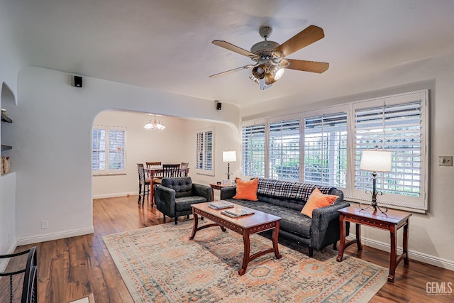 2849 Alturas Dr, Bakersfield, CA 93305 - living room with baseboards, arched walkways, wood finished floors, and ceiling fan with notable chandelier