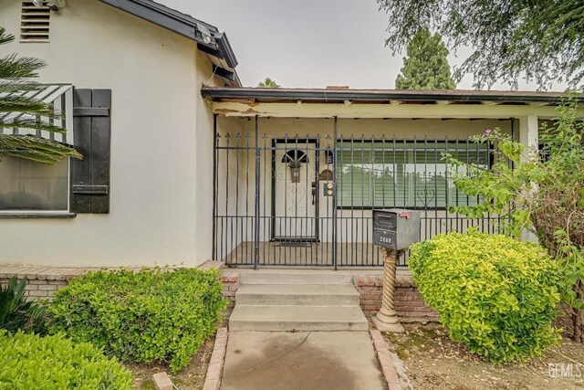 2849 Alturas Dr, Bakersfield, CA 93305 - entrance to property with a gate, stucco siding, and fence