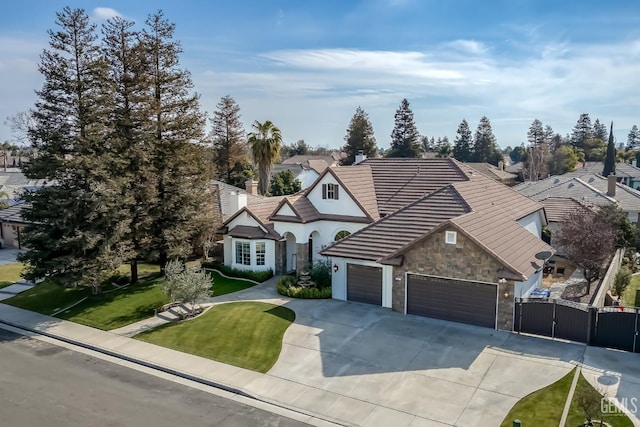 view of front of house with a garage and a front lawn