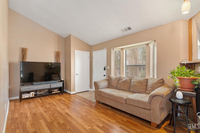 7800 Westfield Rd Unit 28, Bakersfield, CA 93309 - living room with vaulted ceiling, wood finished floors, and a textured ceiling