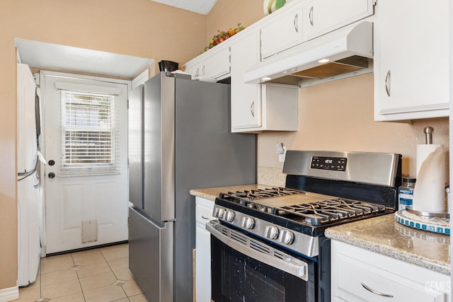 7800 Westfield Rd Unit 28, Bakersfield, CA 93309 - kitchen featuring stainless steel range with gas cooktop, under cabinet range hood, white cabinetry, white fridge, and light tile patterned floors