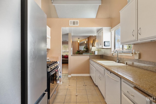 7800 Westfield Rd Unit 28, Bakersfield, CA 93309 - kitchen featuring stainless steel appliances, white cabinets, light tile patterned flooring, and light countertops
