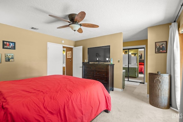 bedroom with light carpet, baseboards, visible vents, ceiling fan, and a textured ceiling