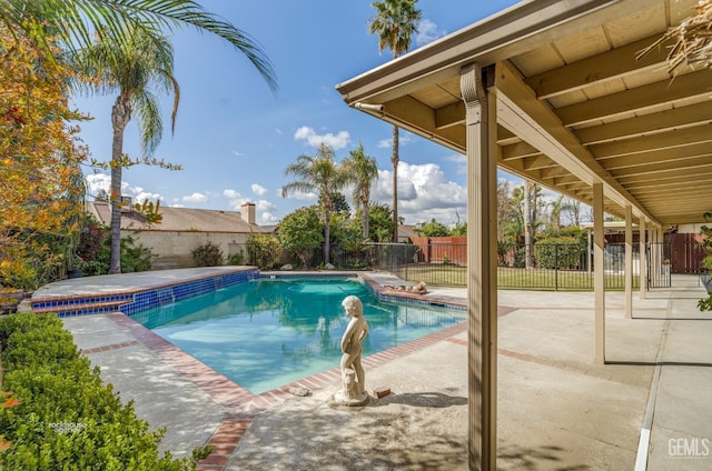 view of swimming pool featuring a fenced in pool, a fenced backyard, and a patio