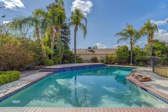 view of swimming pool with a fenced in pool and fence