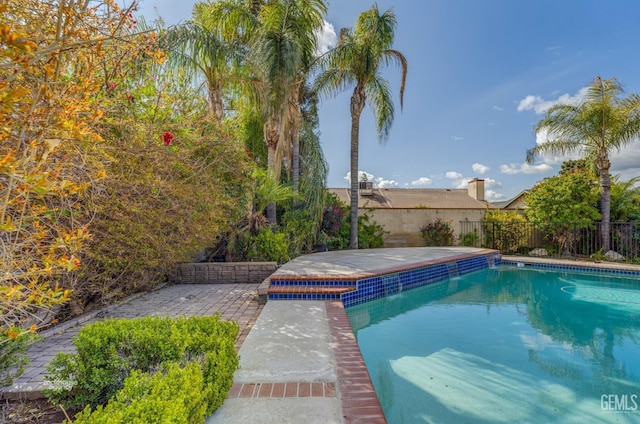 view of pool with a patio area, fence, and a fenced in pool