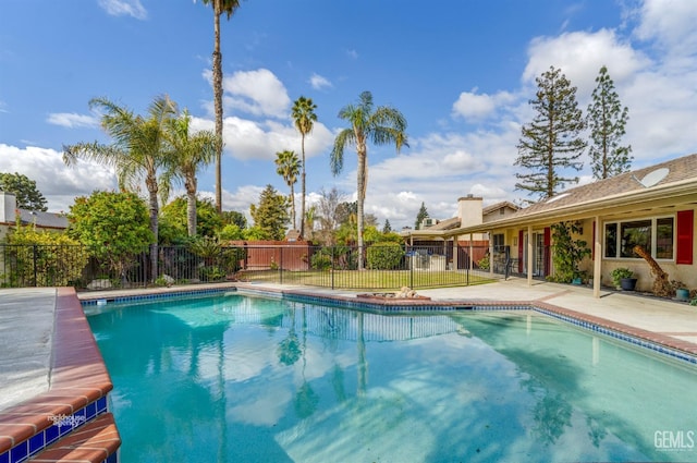 view of swimming pool featuring a patio area, fence, and a fenced in pool