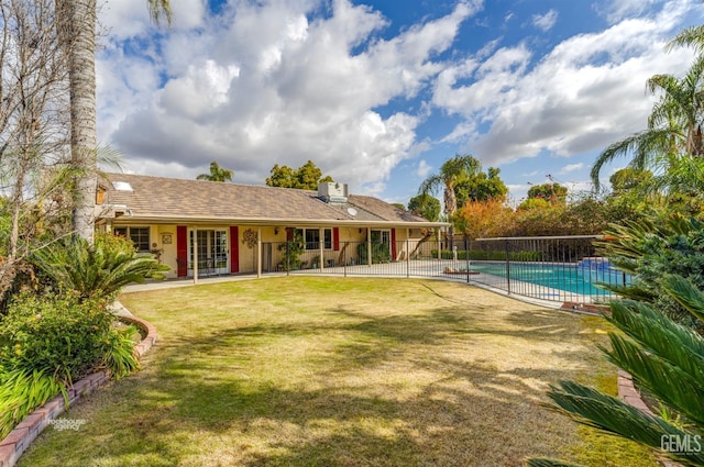 exterior space with a lawn, fence, a fenced in pool, and a patio