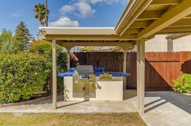 view of patio with fence and area for grilling