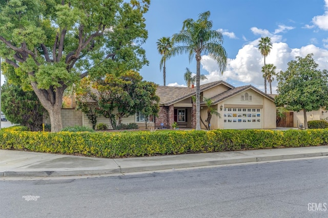 single story home featuring an attached garage and stucco siding