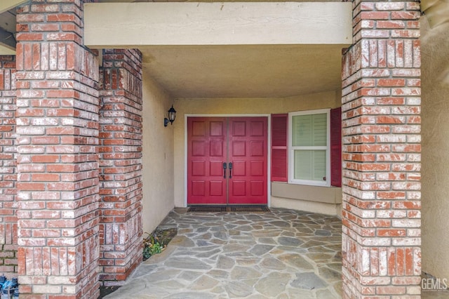 property entrance featuring brick siding