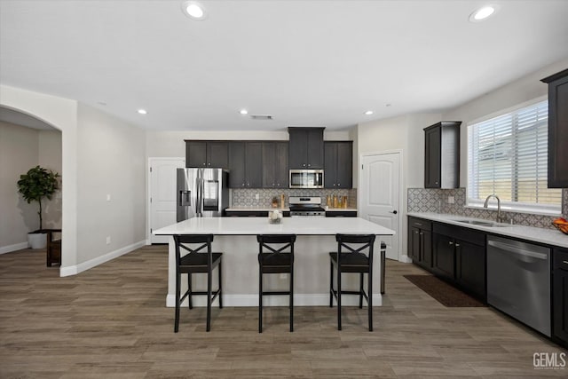 5503 Giverny Way, Bakersfield, CA 93306 - kitchen with appliances with stainless steel finishes, a sink, a kitchen breakfast bar, a center island, and recessed lighting