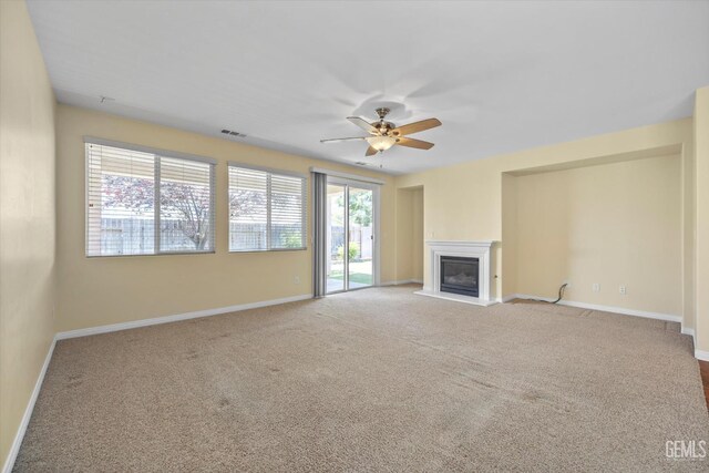 12415 Childress St, Bakersfield, CA 93312 - unfurnished living room featuring a ceiling fan, a glass covered fireplace, carpet floors, and baseboards