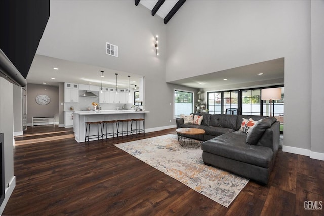 living room featuring beam ceiling, high vaulted ceiling, and dark hardwood / wood-style flooring