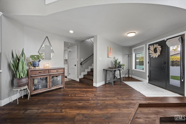 entryway with dark hardwood / wood-style flooring