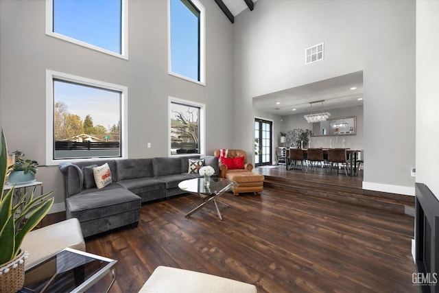 living room with dark hardwood / wood-style floors and a chandelier