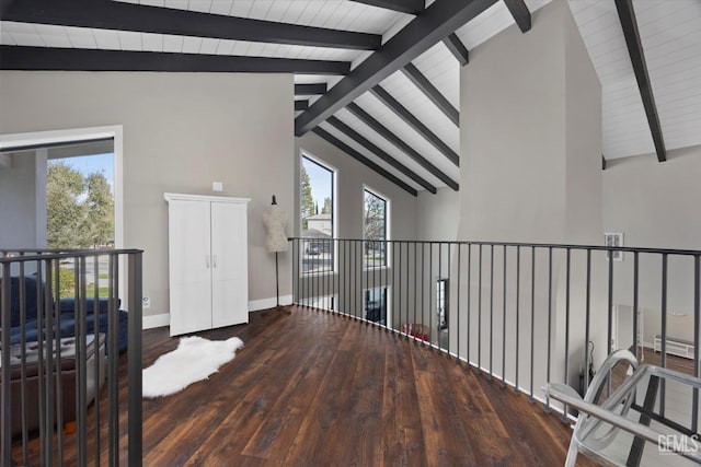 interior space with dark hardwood / wood-style flooring and vaulted ceiling with beams