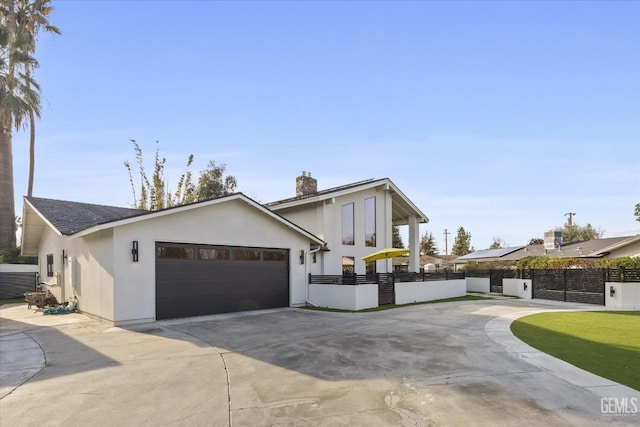 exterior space with central AC unit and a garage