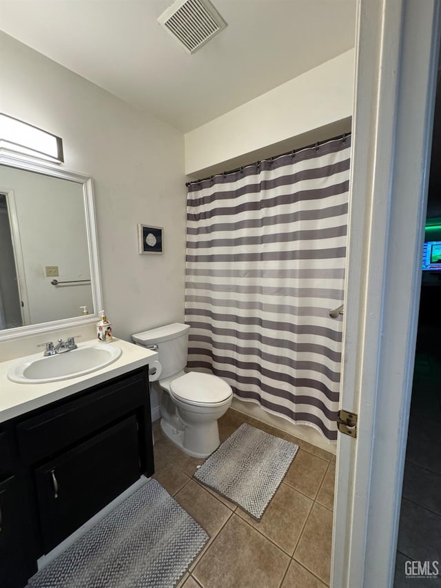 6301 Scenic Way, Bakersfield, CA 93309 - full bathroom with tile patterned floors, toilet, vanity, and curtained shower