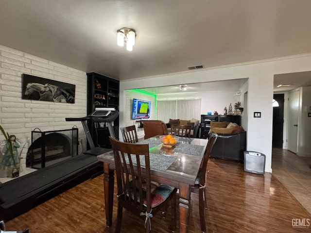 6301 Scenic Way, Bakersfield, CA 93309 - dining space featuring wood finished floors and a brick fireplace
