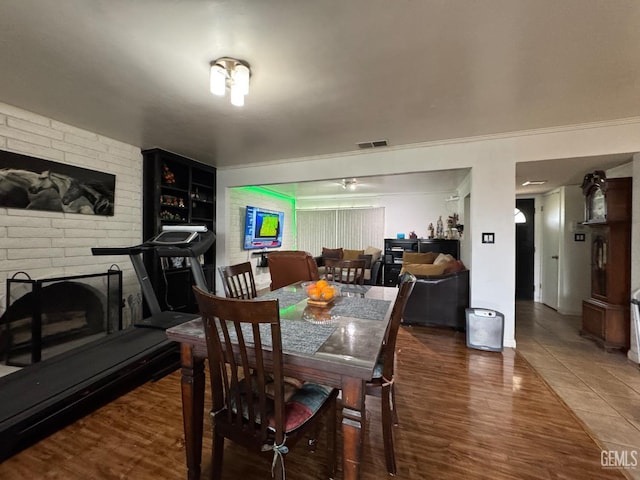 6301 Scenic Way, Bakersfield, CA 93309 - dining room with wood finished floors and a brick fireplace