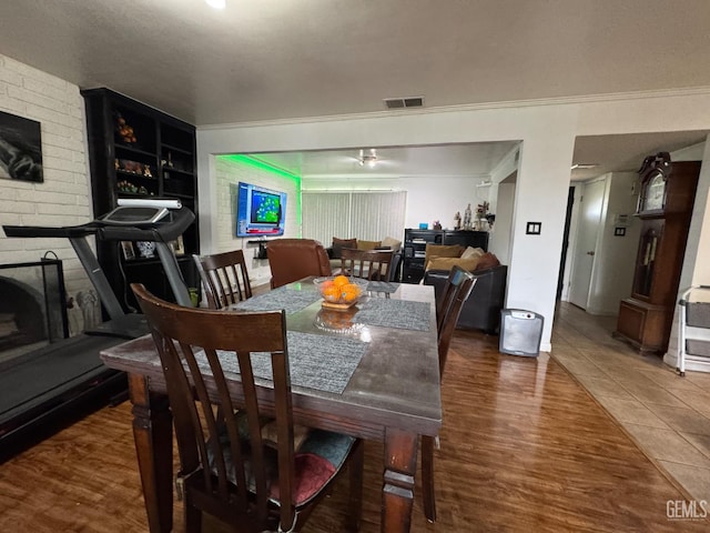 6301 Scenic Way, Bakersfield, CA 93309 - dining space with ornamental molding, a large fireplace, and wood finished floors