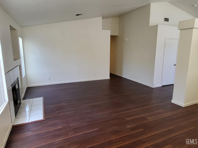 11511 Bay Meadows Ln, Bakersfield, CA 93312 - unfurnished living room featuring wood finished floors, a tiled fireplace, and lofted ceiling