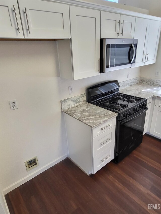 11511 Bay Meadows Ln, Bakersfield, CA 93312 - kitchen with black range with gas cooktop, stainless steel microwave, dark wood-type flooring, and light stone countertops