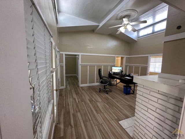 office area featuring a ceiling fan, wood tiled floor, beam ceiling, and high vaulted ceiling