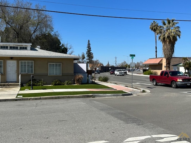 view of road with street lighting, curbs, and sidewalks