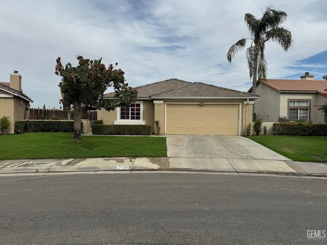 ranch-style house with a garage and a front lawn